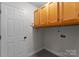 Functional laundry room with overhead cabinets and utility connections at 196 Gabriel Dr, Mooresville, NC 28115