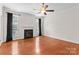 Living room with a cozy fireplace and large windows, showcasing the hardwood floors at 196 Gabriel Dr, Mooresville, NC 28115
