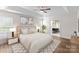 Elegant bedroom with a tray ceiling, hardwood floors, and ensuite bathroom at 196 Gabriel Dr, Mooresville, NC 28115