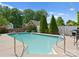 Sparkling swimming pool with lush greenery, manicured evergreens, and fenced in yard for privacy at 196 Gabriel Dr, Mooresville, NC 28115