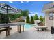 Inviting pool area featuring a striped umbrella, patio seating, and beautifully landscaped backyard at 196 Gabriel Dr, Mooresville, NC 28115