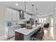 Beautiful kitchen featuring white cabinets, stainless steel appliances, and a large island with breakfast bar seating at 2013 Hamorton Pl, Charlotte, NC 28205