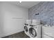 Laundry room with wave wallpaper and modern washer and dryer at 2013 Hamorton Pl, Charlotte, NC 28205