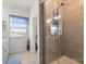 Bright bathroom featuring a glass-enclosed shower, double sinks, and a window with natural light at 2147 Stevens Mill Rd, Matthews, NC 28104