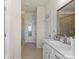 Bright bathroom featuring a glass-enclosed shower, double sinks, and a window with natural light at 2147 Stevens Mill Rd, Matthews, NC 28104
