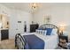 Comfortable bedroom with stylish decor, wrought iron bed frame, and warm natural light at 2147 Stevens Mill Rd, Matthews, NC 28104
