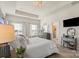 Bright bedroom with large windows, tray ceiling, a tufted headboard, and neutral decor for a relaxing retreat at 2147 Stevens Mill Rd, Matthews, NC 28104