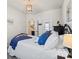 Cozy bedroom with wrought iron bed frame, ensuite bathroom, and hanging chandelier at 2147 Stevens Mill Rd, Matthews, NC 28104