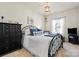 Bright bedroom featuring black dresser, wrought iron bed frame, and window at 2147 Stevens Mill Rd, Matthews, NC 28104