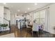 Bright dining area features hardwood floors, large windows, and a modern chandelier at 2147 Stevens Mill Rd, Matthews, NC 28104