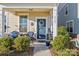 Covered front porch featuring rocking chairs, blue door with wreath, and inviting welcome sign at 2147 Stevens Mill Rd, Matthews, NC 28104