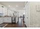 Bright kitchen with stainless steel appliances and granite countertops flowing into the living area at 2147 Stevens Mill Rd, Matthews, NC 28104