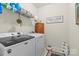Well-organized laundry room with modern appliances and ample storage space for cleaning supplies at 2147 Stevens Mill Rd, Matthews, NC 28104