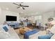 Open-concept living room with modern furniture, fireplace, hardwood floors, and adjacent kitchen at 2147 Stevens Mill Rd, Matthews, NC 28104