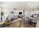 Spacious living room featuring a sectional sofa, hardwood floors, and adjacent kitchen at 2147 Stevens Mill Rd, Matthews, NC 28104