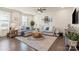 Bright living room with large sectional sofa, modern coffee table, hardwood floors, and natural light at 2147 Stevens Mill Rd, Matthews, NC 28104