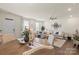 Bright living room featuring a large sectional sofa, hardwood floors, and open dining area at 2147 Stevens Mill Rd, Matthews, NC 28104