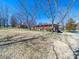 Back view of brick home with lawn and mature trees at 2310 Clay St, Kannapolis, NC 28083