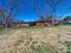 Backyard view of a brick home with a covered carport and mature trees at 2310 Clay St, Kannapolis, NC 28083
