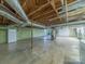Unfinished basement with concrete floor, wood beams, and essential utilities at 2310 Clay St, Kannapolis, NC 28083