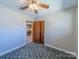 Bedroom featuring a ceiling fan, closet and patterned carpeting at 2310 Clay St, Kannapolis, NC 28083