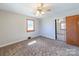 Cozy bedroom with a ceiling fan, natural light, and a mirrored closet at 2310 Clay St, Kannapolis, NC 28083