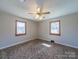 Bedroom featuring a ceiling fan, two windows and patterned carpeting at 2310 Clay St, Kannapolis, NC 28083