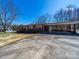 Brick ranch home with attached carport, established landscaping and long driveway at 2310 Clay St, Kannapolis, NC 28083