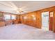 Open living space with wood walls, a vintage ceiling fan, and natural light at 2310 Clay St, Kannapolis, NC 28083