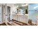 Bright bathroom with dual vanities, decorative mirrors, hardwood floors and a clean, modern design at 255 Dorothy Dr, China Grove, NC 28023