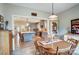Inviting dining area and open kitchen featuring a central island, hardwood floors, and stylish pendant lighting at 255 Dorothy Dr, China Grove, NC 28023