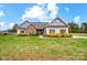 Charming single-story home with stone accents, blue shutters, and beautifully landscaped front yard at 255 Dorothy Dr, China Grove, NC 28023