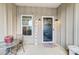 Cozy front porch featuring a quaint seating area, a decorative welcome sign, and stylish outdoor lighting fixtures at 255 Dorothy Dr, China Grove, NC 28023