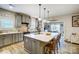 Spacious gray kitchen with large island, pendant lighting, stainless appliances, and dining area view at 255 Dorothy Dr, China Grove, NC 28023