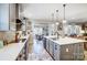 Bright, gray kitchen with a large island, stainless steel appliances, and view to living and dining area at 255 Dorothy Dr, China Grove, NC 28023
