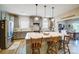 Gray kitchen with island and barstool seating, stainless appliances, and views to a dining area at 255 Dorothy Dr, China Grove, NC 28023