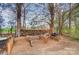 Outdoor storage area with stacked firewood and various containers at 255 Dorothy Dr, China Grove, NC 28023