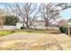 Spacious backyard features a wooden deck, a shed, and a well-maintained lawn, perfect for outdoor activities and relaxation at 2702 Robyns Glen Dr, Charlotte, NC 28269
