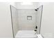 Bathroom highlighting the bright white tiled shower and vaulted ceiling at 2702 Robyns Glen Dr, Charlotte, NC 28269