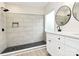 Bathroom featuring tile walk-in shower and white vanity with dual black round mirrors at 2702 Robyns Glen Dr, Charlotte, NC 28269