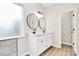 Bathroom featuring a walk-in shower and a double sink vanity with round mirrors at 2702 Robyns Glen Dr, Charlotte, NC 28269
