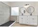 Bathroom featuring walk-in shower and white vanity with dual black round mirrors at 2702 Robyns Glen Dr, Charlotte, NC 28269