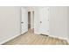 This bedroom has an open doorway and beautiful wood-look flooring throughout at 2702 Robyns Glen Dr, Charlotte, NC 28269