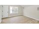 This bright bedroom features hardwood-look floors and a large window at 2702 Robyns Glen Dr, Charlotte, NC 28269