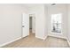 Bright bedroom featuring wood-look flooring, a large window, and an open doorway at 2702 Robyns Glen Dr, Charlotte, NC 28269