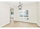 Modern dining area features laminate floors, a stylish light fixture, and large window offering natural light at 2702 Robyns Glen Dr, Charlotte, NC 28269