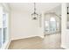 Bright dining room with modern light fixture, ample windows, and new wood floors at 2702 Robyns Glen Dr, Charlotte, NC 28269