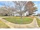 Charming home with a well-manicured lawn, mature trees, and a welcoming front porch at 2702 Robyns Glen Dr, Charlotte, NC 28269