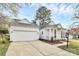 One-story home showcasing a garage and covered porch with traditional white columns and dark shutters at 2702 Robyns Glen Dr, Charlotte, NC 28269