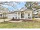 Charming one-story home featuring a covered front porch with classic white columns and manicured landscaping at 2702 Robyns Glen Dr, Charlotte, NC 28269